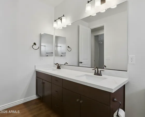 a bedroom with a bed and a wooden floor