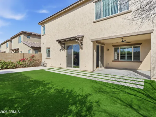 a view of a house with a large windows and a yard