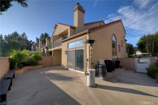 a view of a patio with table and chairs potted plants