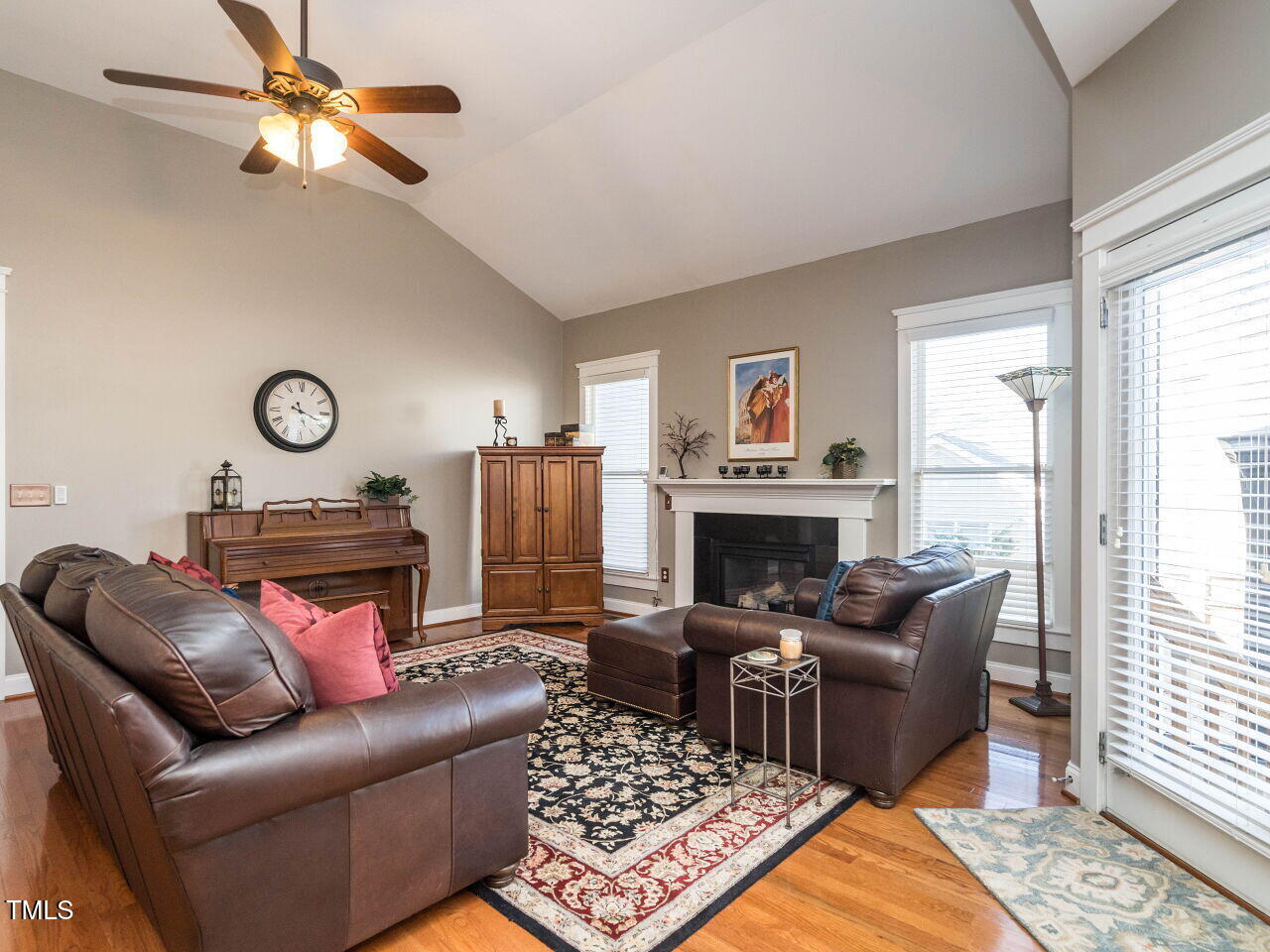 114 Naperville Drive Cary, NC 27519 - Photo 13 of 36 a living room with furniture a fireplace and a window