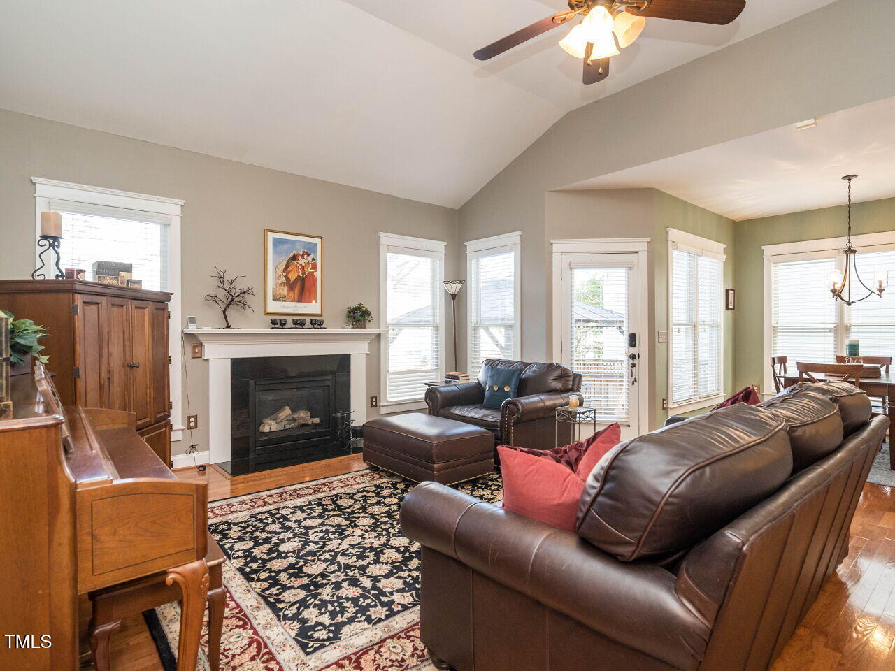 114 Naperville Drive Cary, NC 27519 - Photo 14 of 36 a living room with furniture a flat screen tv and a fireplace