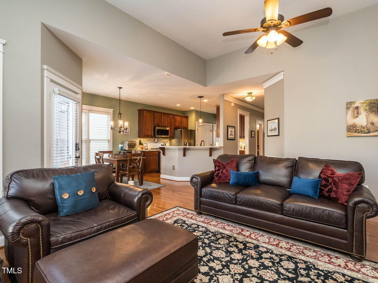 114 Naperville Drive Cary, NC 27519 - Photo 15 of 36 a living room with furniture ceiling fan and a rug
