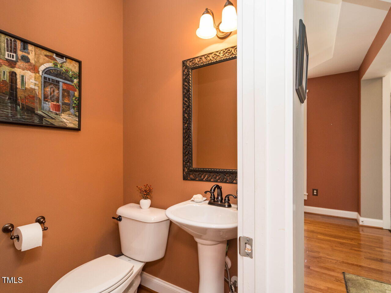 114 Naperville Drive Cary, NC 27519 - Photo 16 of 36 a bathroom with a toilet sink and mirror