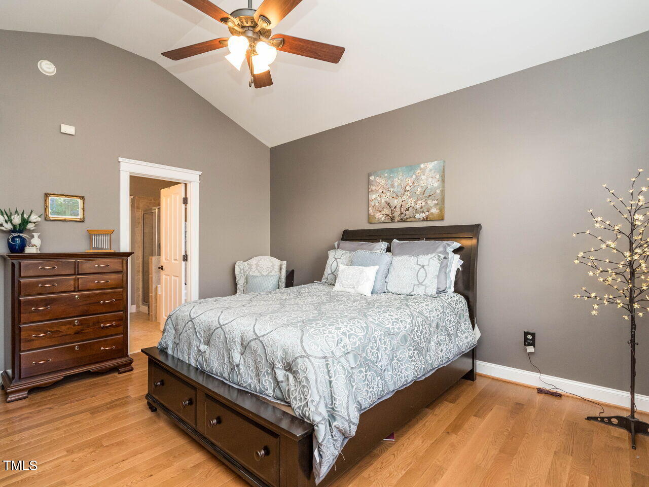 114 Naperville Drive Cary, NC 27519 - Photo 17 of 36 a bedroom with a bed and a chandelier
