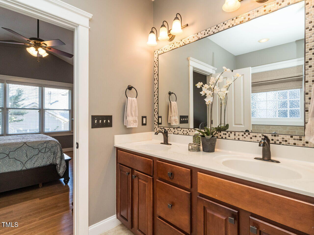 114 Naperville Drive Cary, NC 27519 - Photo 21 of 36 a en suite bathroom with a double vanity sink and a mirror