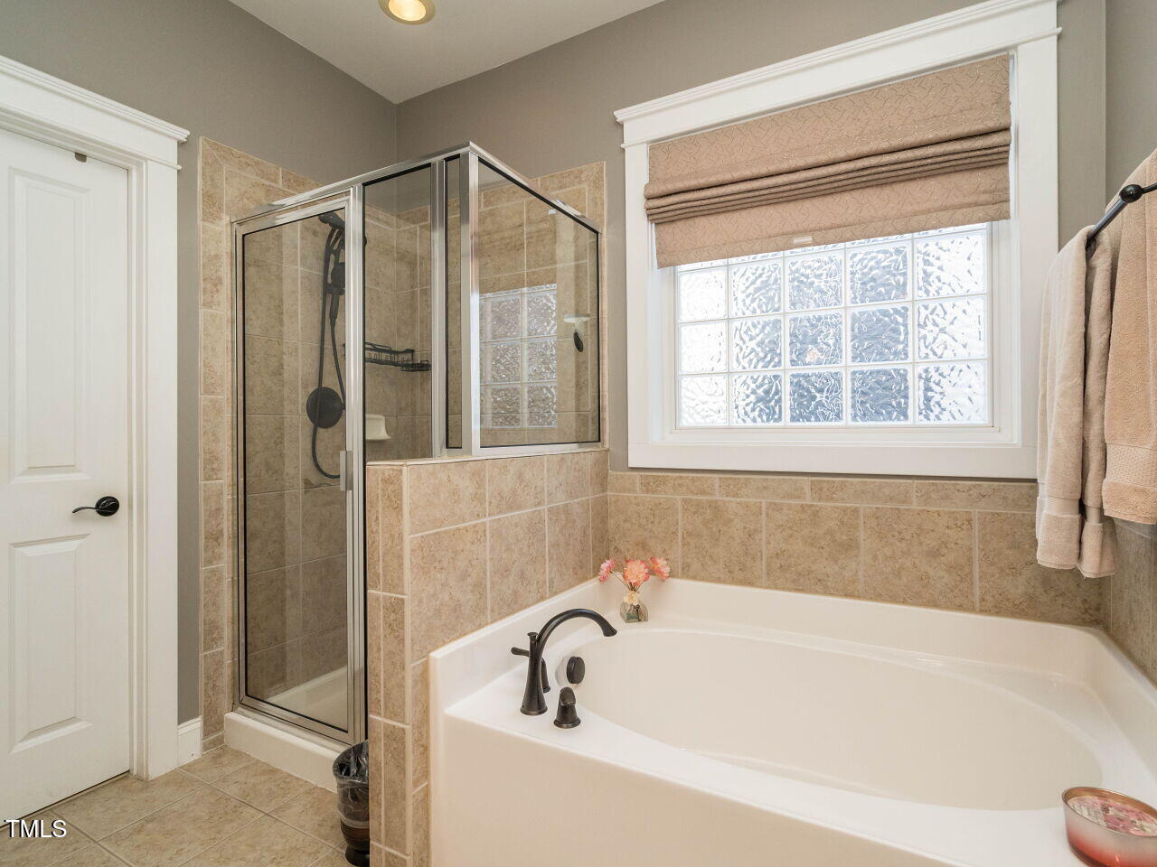 114 Naperville Drive Cary, NC 27519 - Photo 22 of 36 a bathroom with a bathtub and a shower