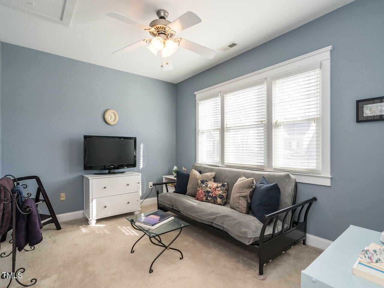 114 Naperville Drive Cary, NC 27519 - Photo 25 of 36 a living room with furniture and a flat screen tv