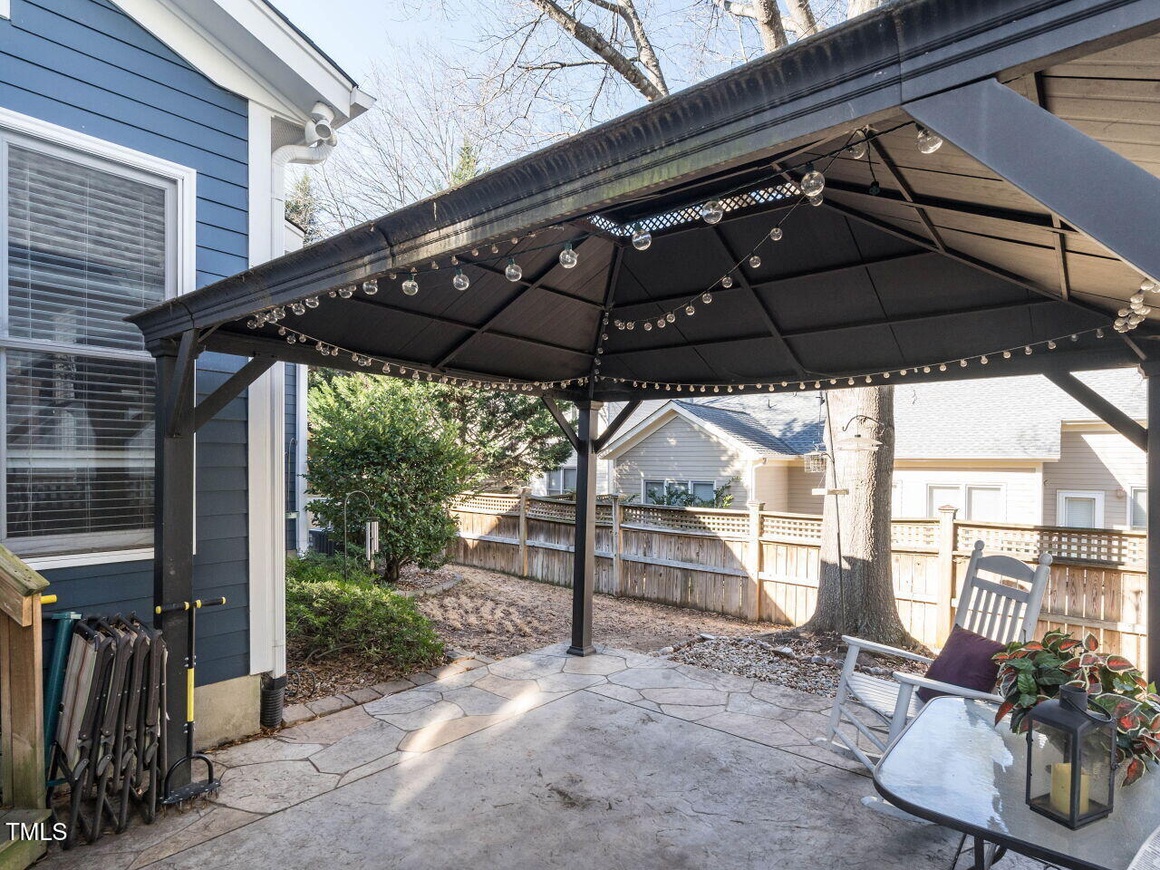 114 Naperville Drive Cary, NC 27519 - Photo 30 of 36 a view of a patio with table and chairs under an umbrella