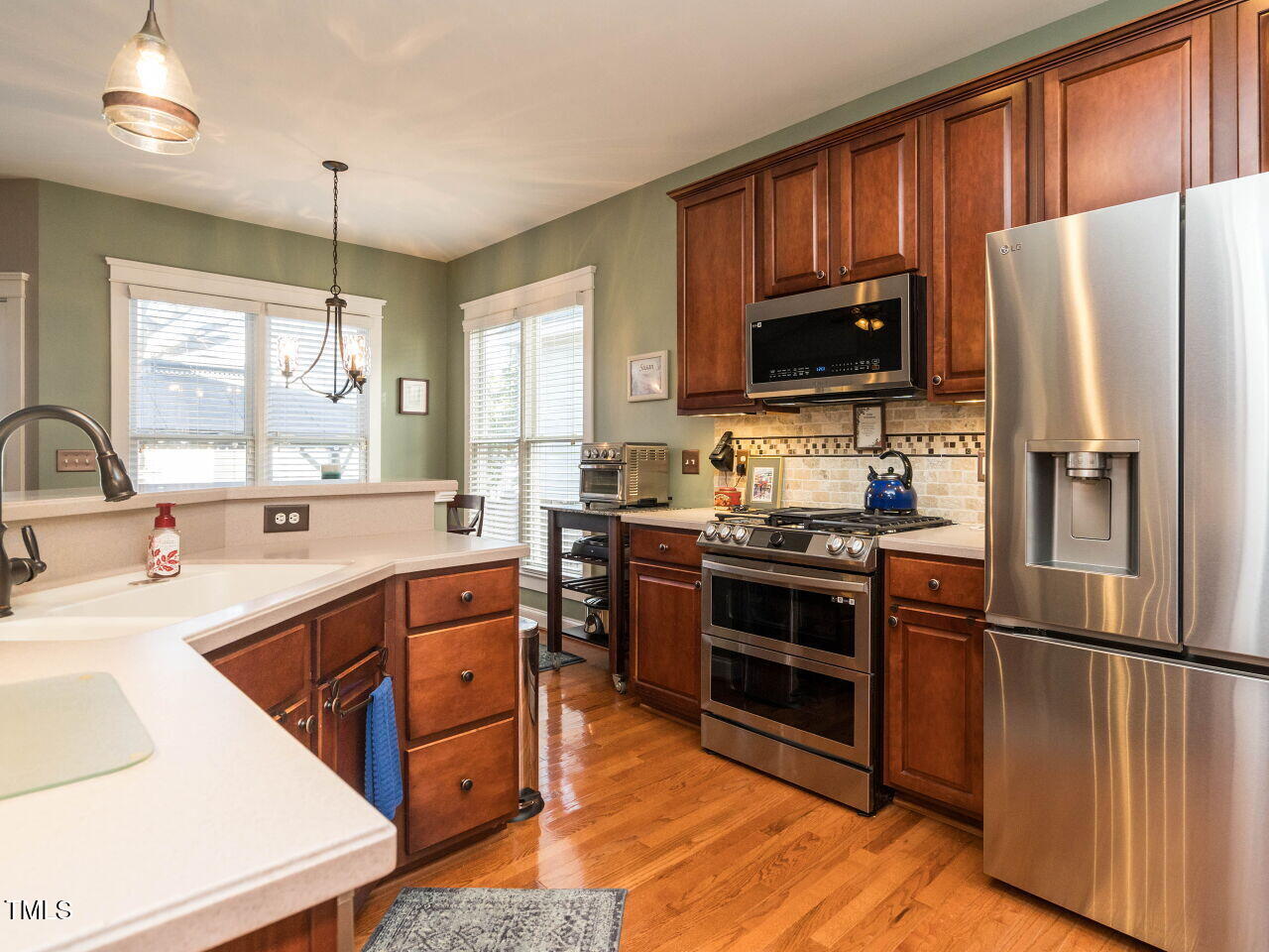 114 Naperville Drive Cary, NC 27519 - Photo 8 of 36 a kitchen with stainless steel appliances granite countertop a refrigerator a stove a sink and a microwave
