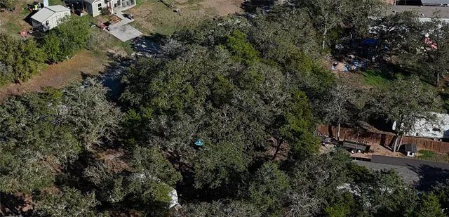 an aerial view of residential houses with outdoor space and river