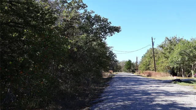 a view of a street with trees