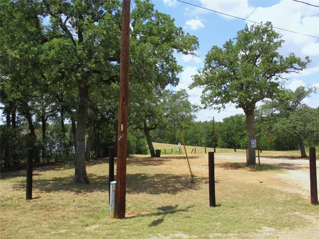 an aerial view of residential house with outdoor space and trees all around