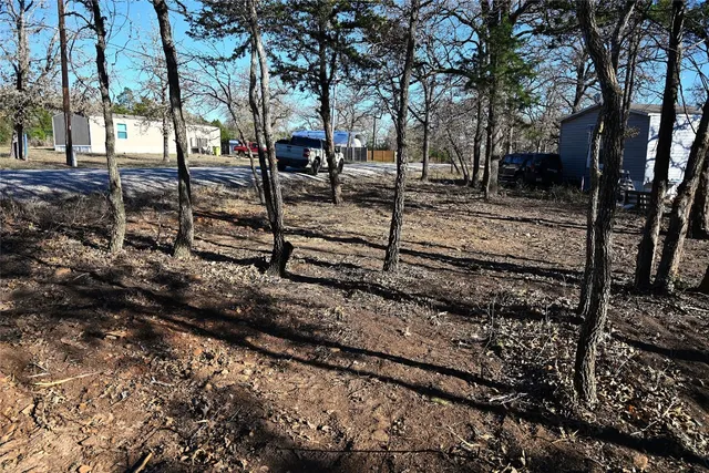 an aerial view of residential houses with outdoor space and lake view