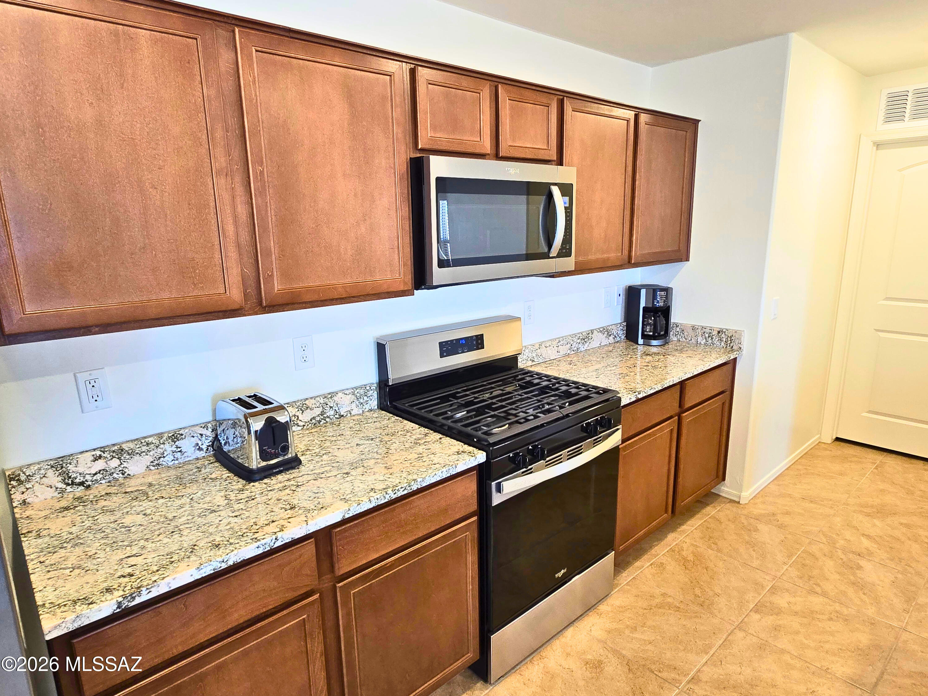 6343 South Rigby Way Tucson, AZ 85746 - Photo 7 of 29 a kitchen with granite countertop cabinets and window