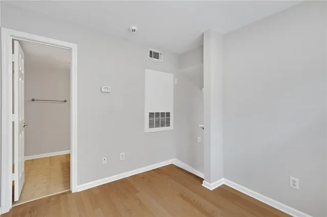 a bathroom with a granite countertop sink toilet and mirror