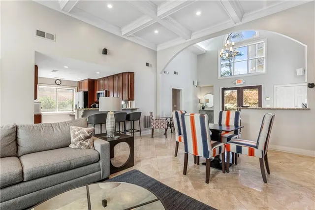 a living room with lots of furniture and a large window