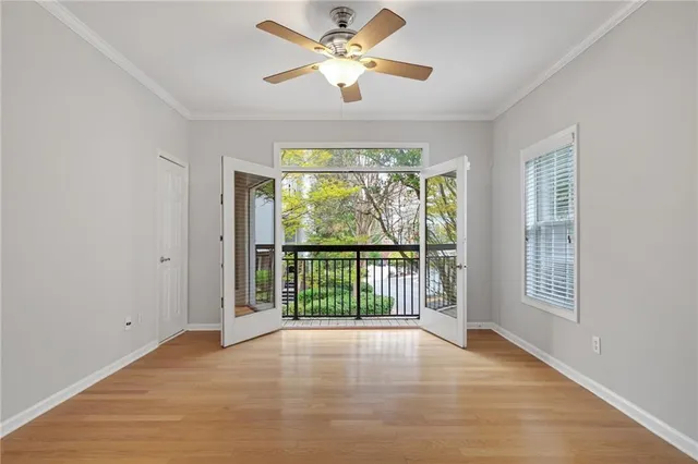 a view of a room with wooden floor and windows