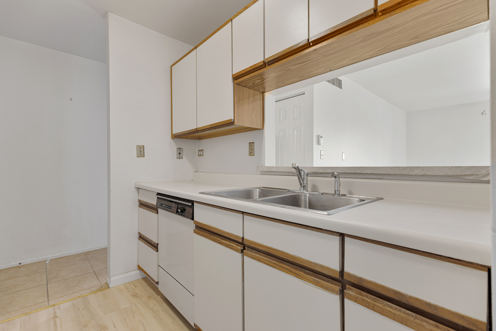 1912 Prairie Square, Unit 209A Schaumburg, IL 60173 - Photo 12 of 26 a kitchen with a sink and cabinets
