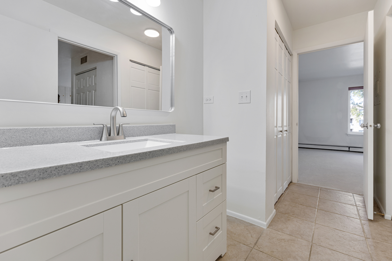 1912 Prairie Square, Unit 209A Schaumburg, IL 60173 - Photo 15 of 26 a bathroom with a sink and a mirror