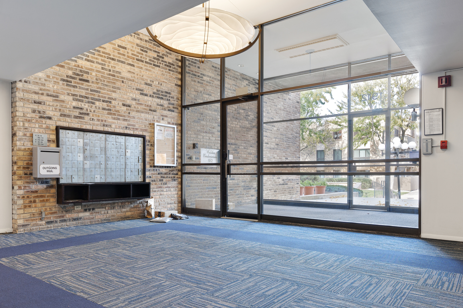 1912 Prairie Square, Unit 209A Schaumburg, IL 60173 - Photo 3 of 26 an empty room with wooden floor and windows