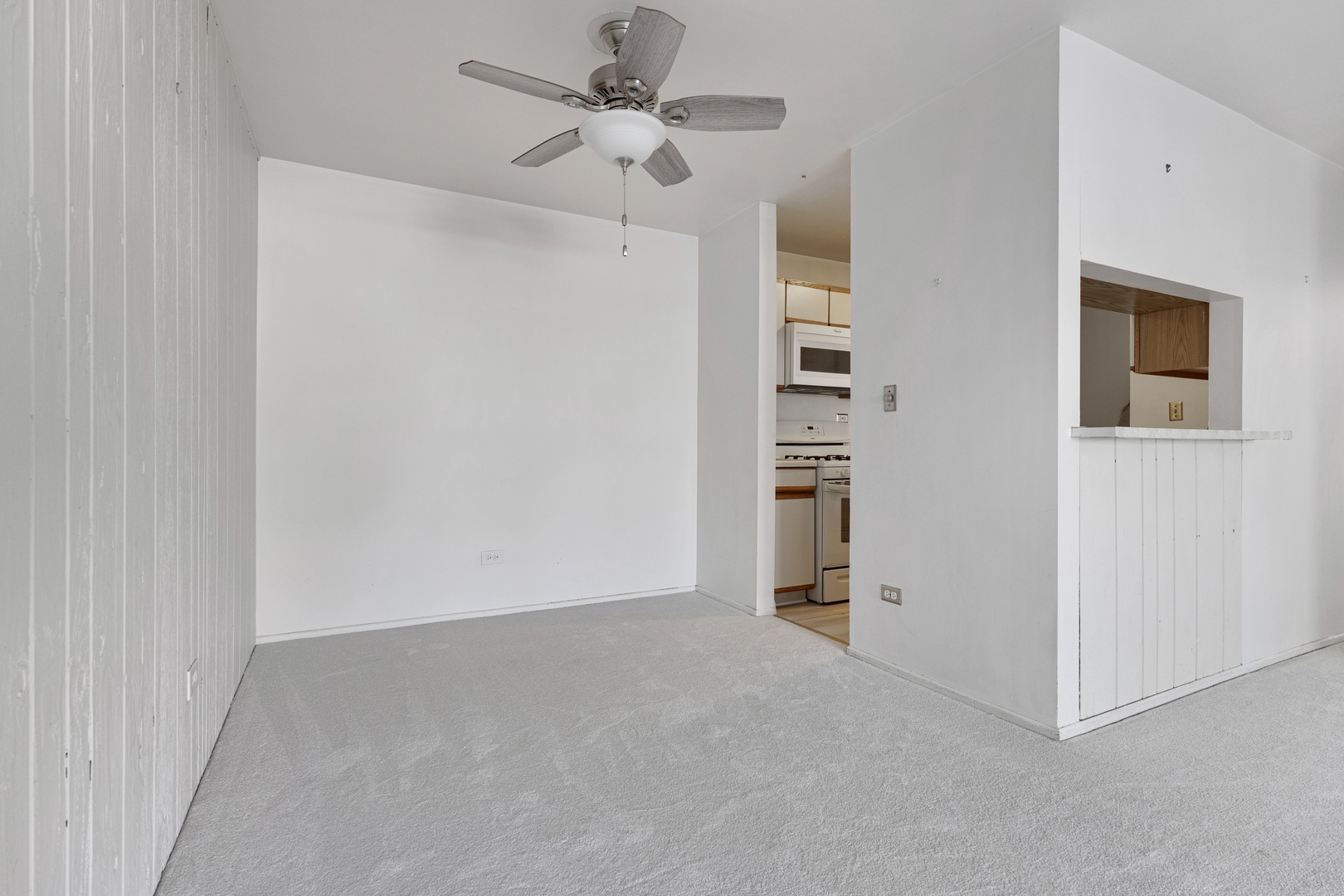 1912 Prairie Square, Unit 209A Schaumburg, IL 60173 - Photo 7 of 26 a view of an empty room with a ceiling fan
