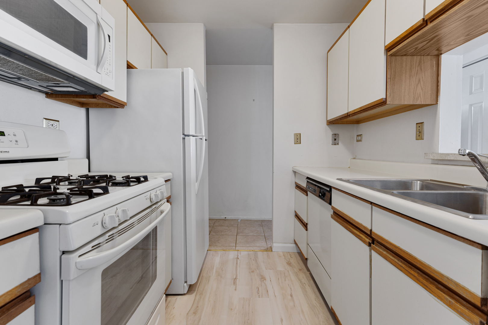 1912 Prairie Square, Unit 209A Schaumburg, IL 60173 - Photo 10 of 26 a kitchen with stainless steel appliances a sink a stove and a refrigerator