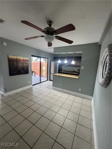 a view of a livingroom with furniture and a ceiling fan