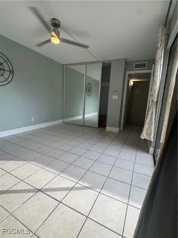 a view of an empty room and a bathroom