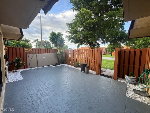 a view of a backyard with wooden fence