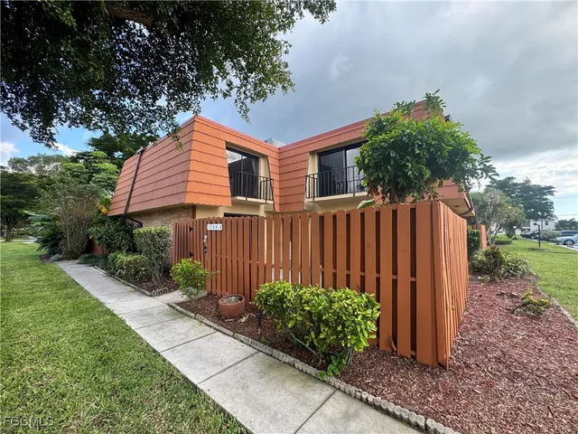 a pathway of a house with a yard