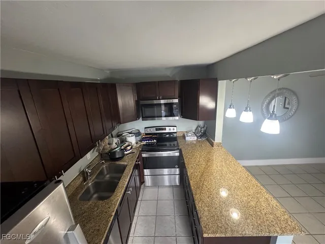 a kitchen with a stove and a refrigerator