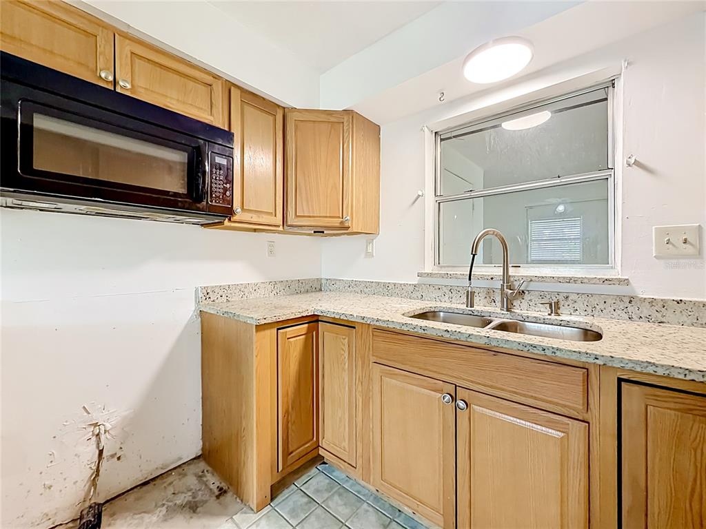 3 Bahia Pl Loop Ocala, FL 34472 - Photo 12 of 31 a kitchen with stainless steel appliances granite countertop a sink and a microwave