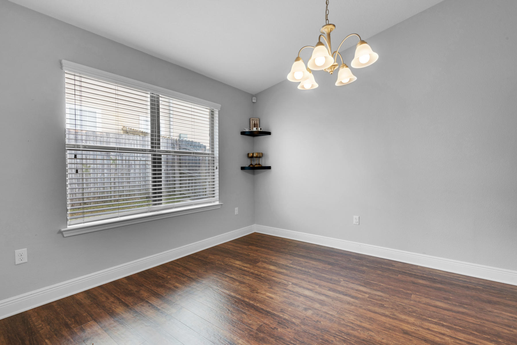 4637 Hermosa Road Crestview, FL 32539 - Photo 14 of 41 a view of a room with wooden floor and windows