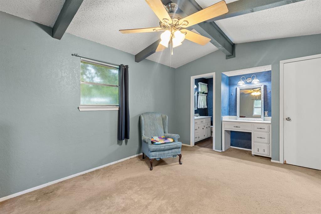 505 Pinewood Lane Hewitt, TX 76643 - Photo 17 of 38 Room featuring a vaulted ceiling with exposed beams, a ceiling fan, and carpeted flooring