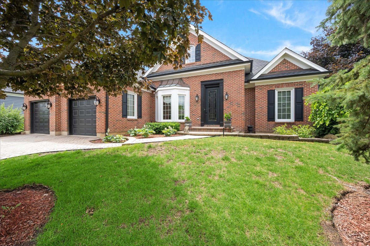 a front view of house with yard and green space