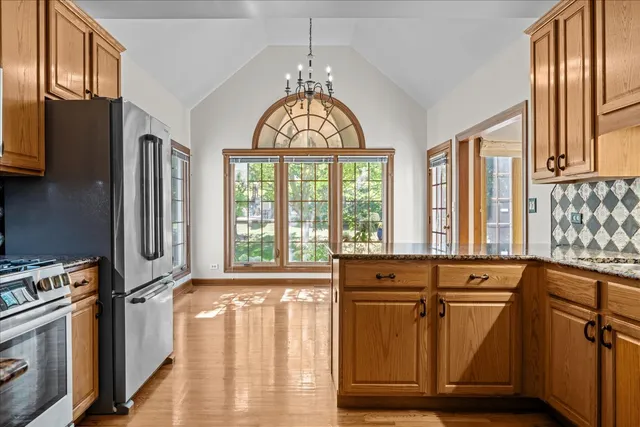 a view of a kitchen with large windows