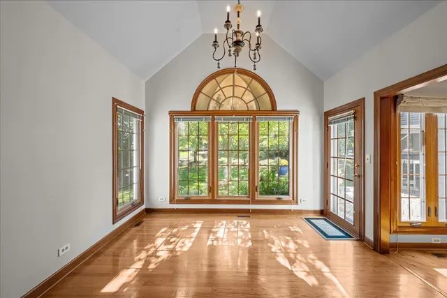 a view of an entryway with wooden floor and a window