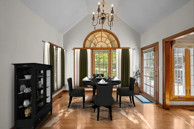 a view of a a dining room with furniture window and wooden floor