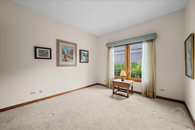 a view of a livingroom with workspace and a window