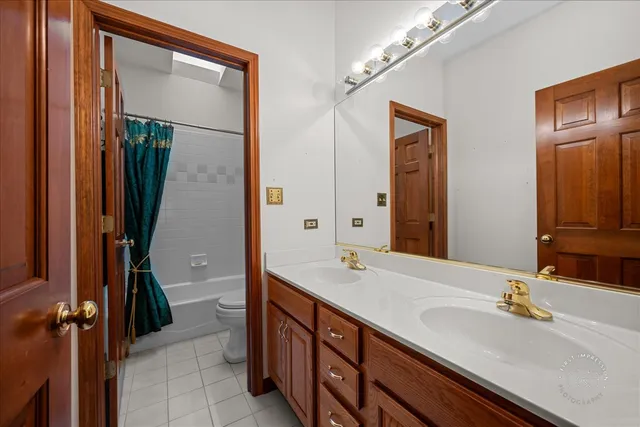 a bathroom with a double vanity sink and a mirror