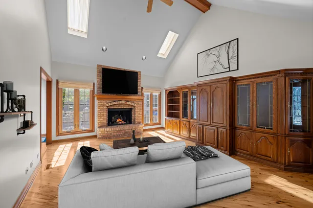 a living room with furniture fireplace and flat screen tv