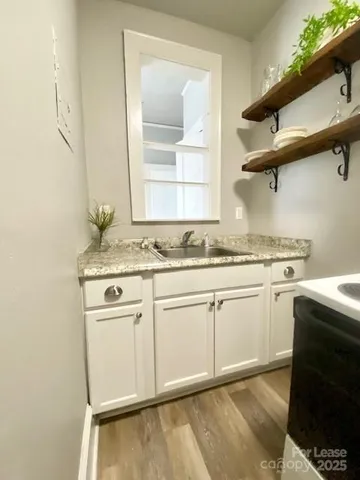 a kitchen with granite countertop cabinets stainless steel appliances and a sink