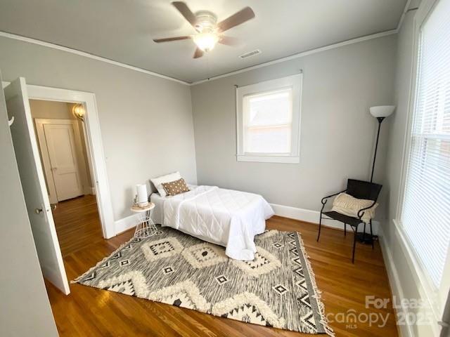 823 Central Avenue, Unit 1 Charlotte, NC 28204 - Photo 8 of 17 a bedroom with a bed and wooden floor