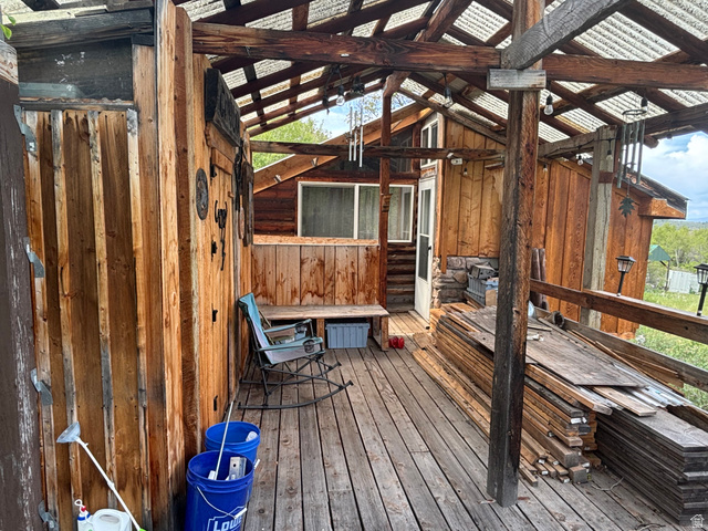 6476 Stauffer Road, Unit 4 Montpelier, ID 83254 - Photo 12 of 17 Covered wood-plank deck with exposed beam ceiling and corrugated translucent roofing