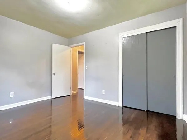 an empty room with wooden floor