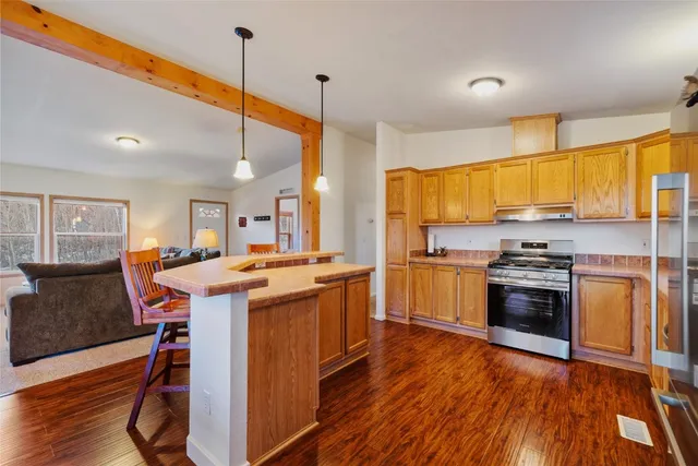 a kitchen with a stove a sink and a refrigerator