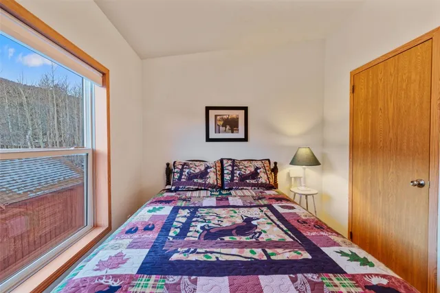 a bed sitting in a bedroom next to a window