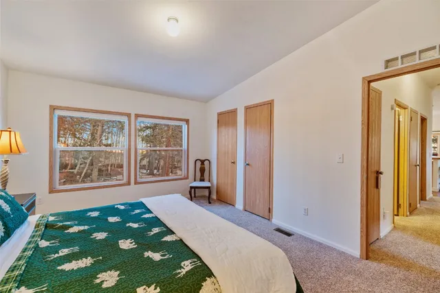 a spacious bedroom with a bed and a window