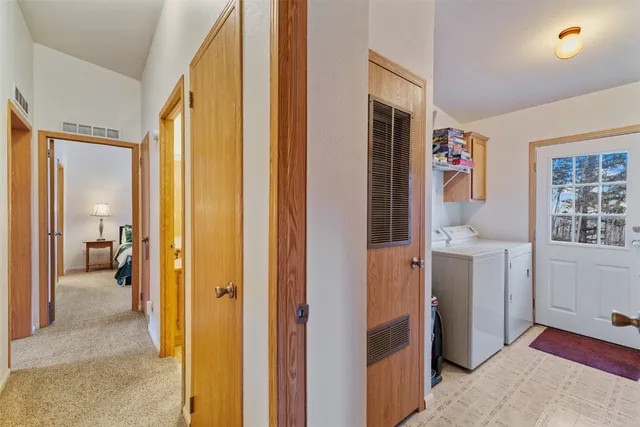 a view of a livingroom with bathroom and furniture