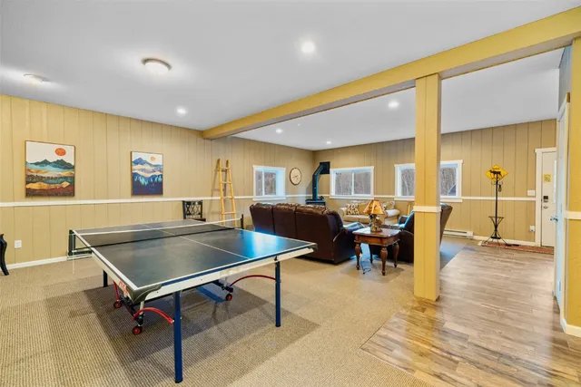 a living room with table tennis pool table and a couch